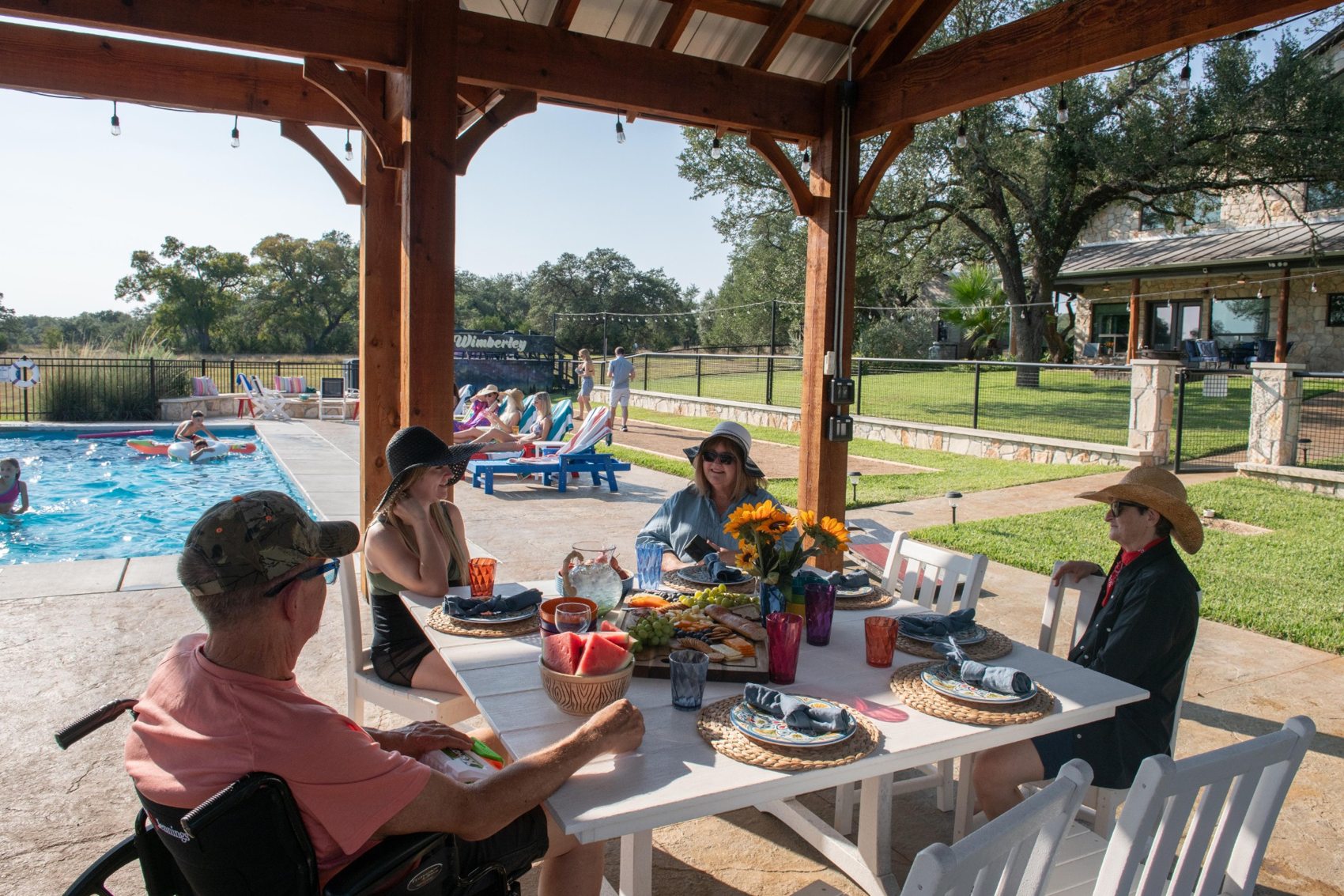 People sharing a meal beneath the pavilion at The Gathering