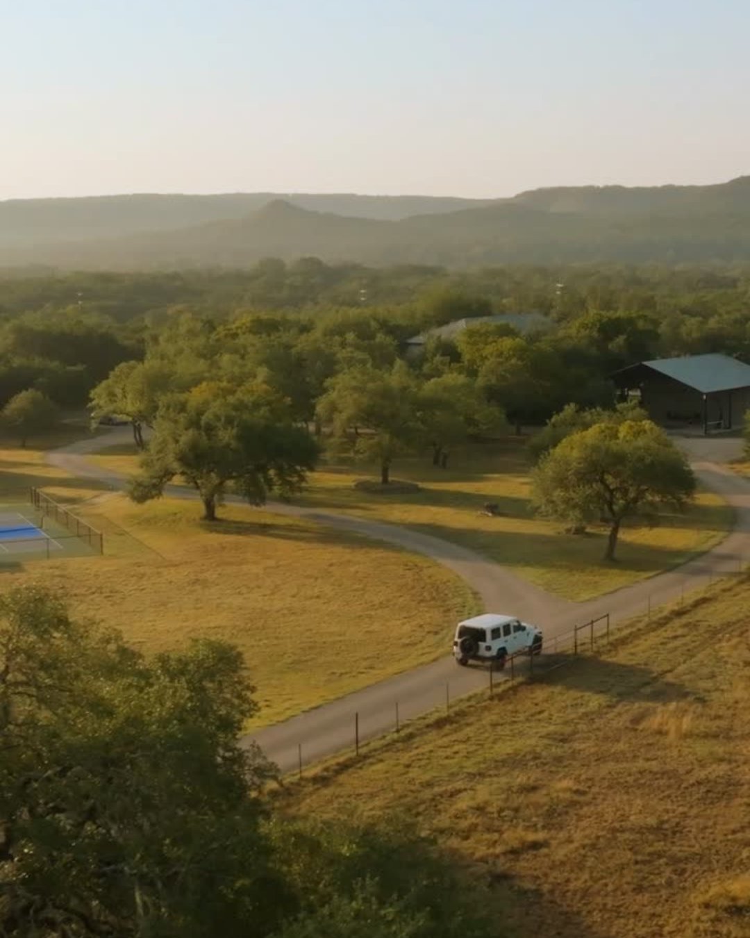 A car arriving along the road through The Gathering’s Hill Country grounds