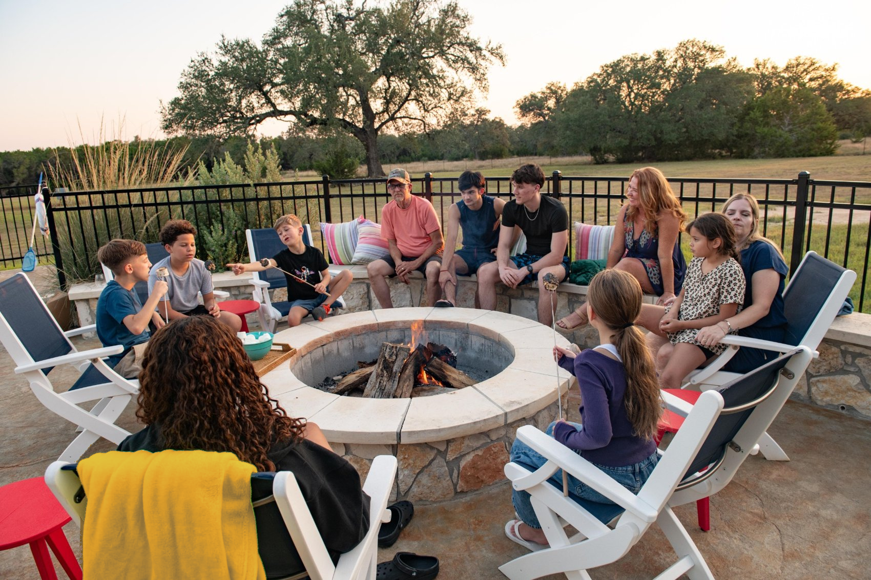 Three generations gathered around the fire pit at The Gathering