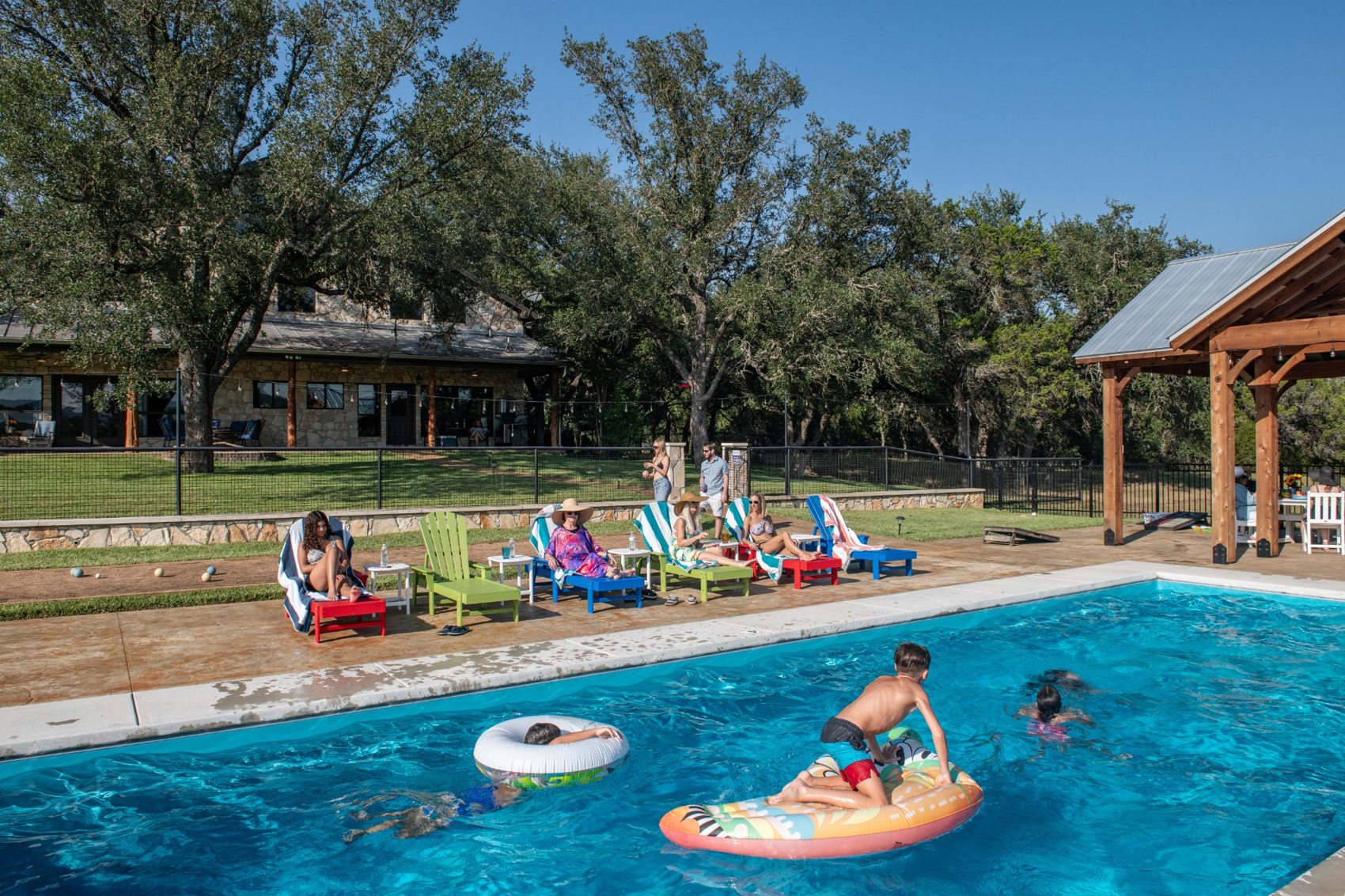 Different generations spending an afternoon around the pool at The Gathering